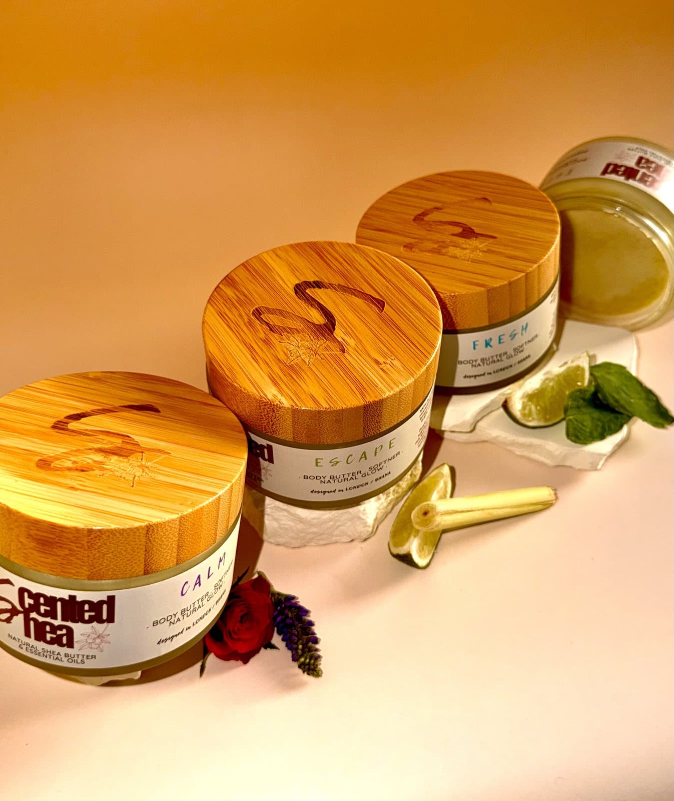 Calm, Escape and Fresh 200g jars in a row, each with its bamboo lid engraved with the Scented Shea mark